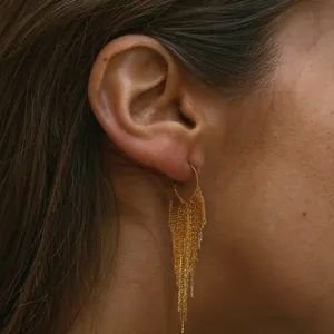 Elegant gold-plated brass tassel drop earrings for women shown on a model