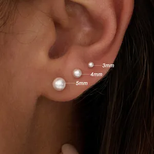 Macro view of mini pearl stud earrings set showing 3mm, 4mm, and 5mm diameter sizes