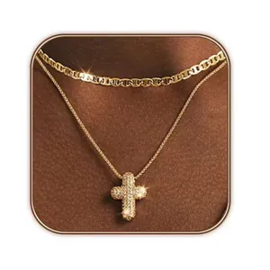 Gold double layer necklace featuring a mariner link and crystal cross pendant on model