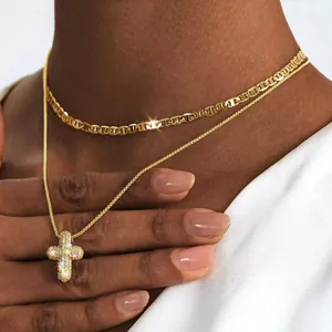 Gold layered necklace with a sparkling cz cross pendant and sleek flat curb chain