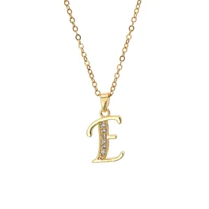 Detail of 18K gold-plated brass necklace with crystal-encrusted letter E pendant