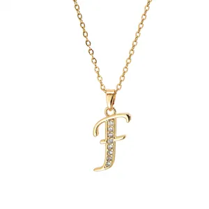 Detail of gold-plated brass letter F pendant with shimmering cubic zirconia inlay