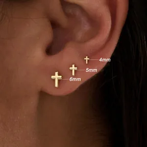 Detailed comparison of 4mm, 5mm, and 6mm gold cross stud earrings on a model ear