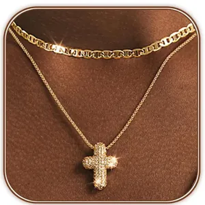 Close-up of layered gold necklaces with sparkling rhinestone hollow cross pendant on neck