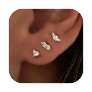 Detailed close-up of three gold-plated starfish butterfly studs with zircons on the ear