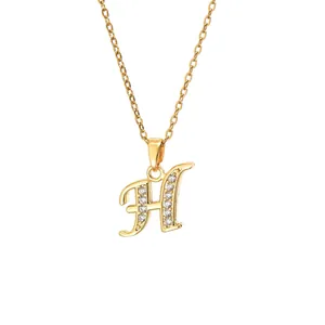 Macro shot of gold-plated letter H pendant necklace with sparkling cubic zirconia inlay