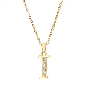 Close-up of golden letter I pendant necklace with sparkling zircon stones in a macro view