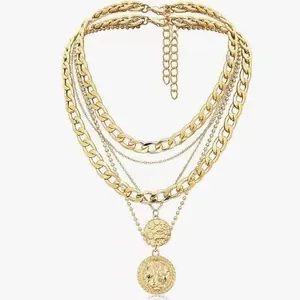 Layered gold necklace featuring chunky cuban links and round embossed coin pendants