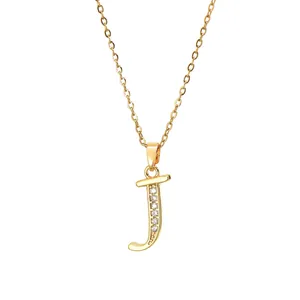 Close-up of gold plated letter J pendant necklace with zircon inlay on dainty chain