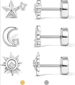 Macro detail of star moon and floral stud earrings set in polished silver and gold