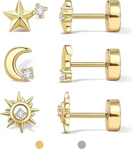 Macro shot of gold-plated celestial earrings with stars and moons featuring zircon stones
