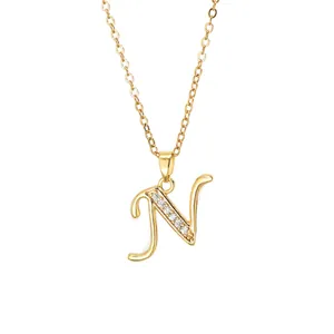 Close-up of gold plated letter N pendant necklace with cubic zirconia on O-chain