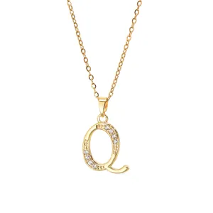 Detailed macro view of gold plated letter Q pendant necklace with inlaid zircon crystals