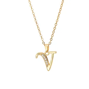 Detail of gold letter V pendant necklace with micro-paved sparkling cubic zirconia stones