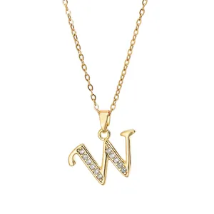 Detail view of gold-plated letter W pendant necklace with white zircon stone setting
