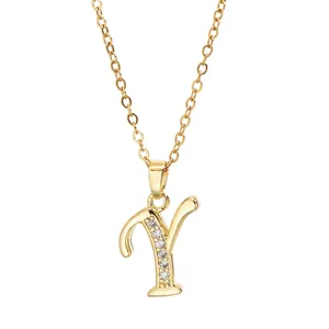 Detail of gold-plated brass letter Y pendant necklace with sparkling cubic zirconia stones