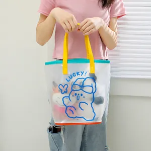 PVC jelly beach bag with cartoon bear and colorful trimmings shown in lifestyle view