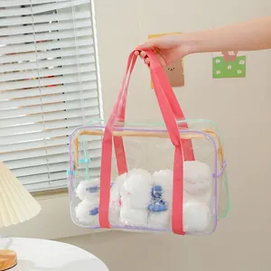 Transparent large PVC tote bag with pink handles and plush bunnies inside for storage
