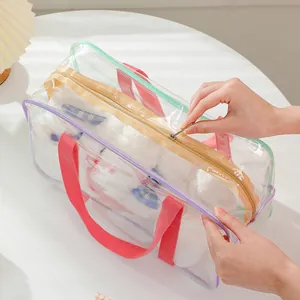 Detail of transparent PVC tote with laser trim and pink handles showing zipper closing