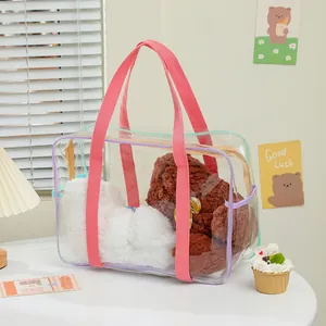 Detail of transparent PVC tote bag with pink straps and colorful pastel zipper accents