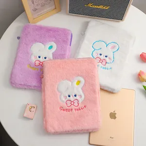 Detail of plush iPad sleeve with cute rabbit embroidery in pink, purple and white colors