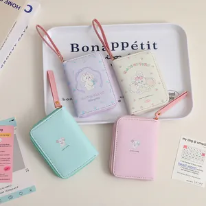 Detailed view of colorful cartoon mini coin purses in pastel purple, cream, and mint