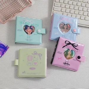 Detail of A8 hollow heart photo albums in mint, blue, and purple with snap closure