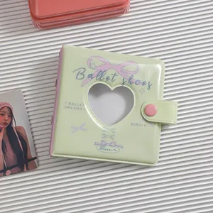 Detail of mint green A8 binder showing heart-shaped cutout and pink snap closure