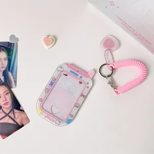 Detailed view of pink cartoon photocard holder with elastic rope and heart pendant detail