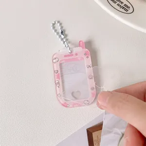 Close-up of peeling the protective film off a pink phone-shaped acrylic photocard holder