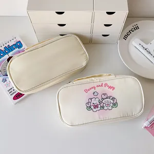 Detail of cream pencil case with bunny and puppy print and sturdy carry handle