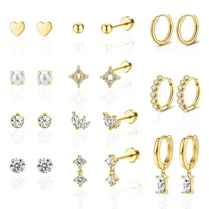 Eleven pairs of gold-plated geometric earrings including studs, hoops and pearl drops