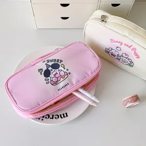 Close-up of pink and white cartoon pencil cases with cute puppy and panda illustrations