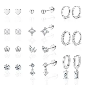 Detailed set of silver-toned stud and hoop earrings featuring crystals and pearls