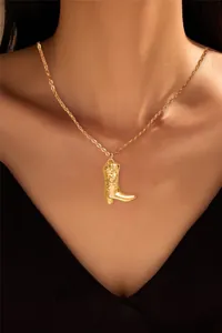 Detailed view of a gold-plated brass boot pendant necklace on a female model