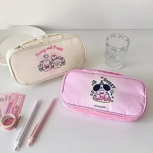 Detail view of cute cartoon puppy and bunny pencil cases with handles and sturdy zippers