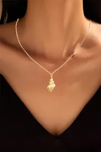 Detail of gold-plated brass necklace featuring a textured conch pendant on a model