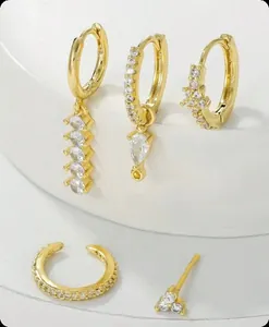 Detail view of 5-piece gold plated brass earring set with zircons and tassels