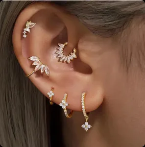 Macro detail of gold plated tassel earrings with marquise cubic zirconia on ear