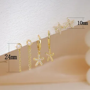 Detailed view of gold starfish earrings and pearl tassels with size specifications