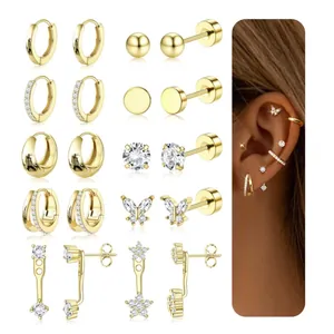 Detailed set of gold plated brass hoop earrings and cubic zirconia studs on model