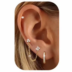 Detail of 18k gold plated brass earring set featuring clover studs and linked chains