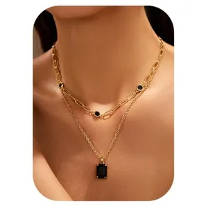 Elegant gold double-layered necklace with black rectangular zircon pendant on model