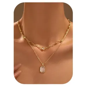 Double-layered gold necklace with paperclip chain and rectangular zircon pendant