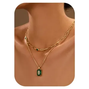 Double layered gold necklace with rectangular green zircon pendant and paperclip chain
