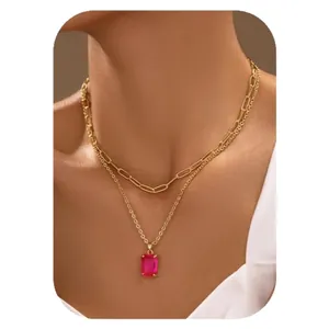 Double layered gold necklace with paperclip chain and rectangular pink zircon pendant