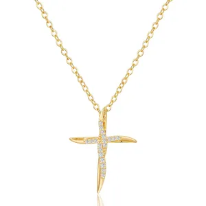 Gold plated brass cross necklace with sparkling zircon stones on a white background
