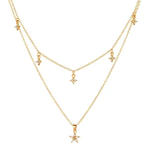 Detail of double-layer gold necklace featuring star charms and floral zircon pendant