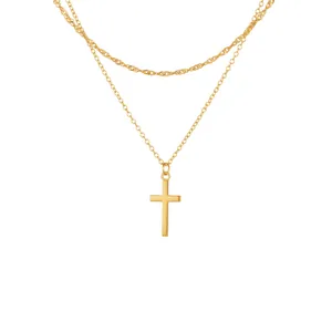 Close-up of double-layer gold plated necklace featuring a zircon crown cross pendant