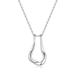 Detail of silver streamlined necklace pendant with high-polished mirror finish